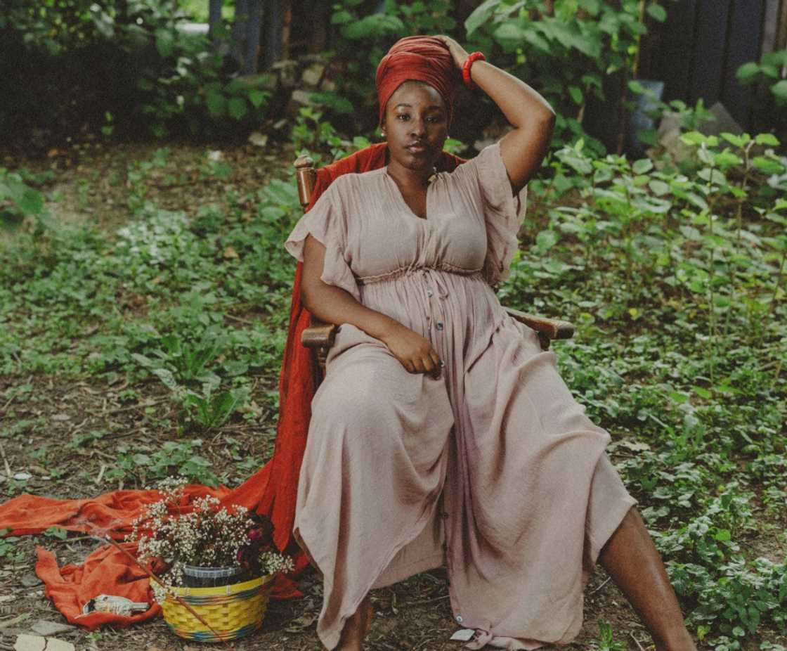 A tired woman sitting on a chair in the garden