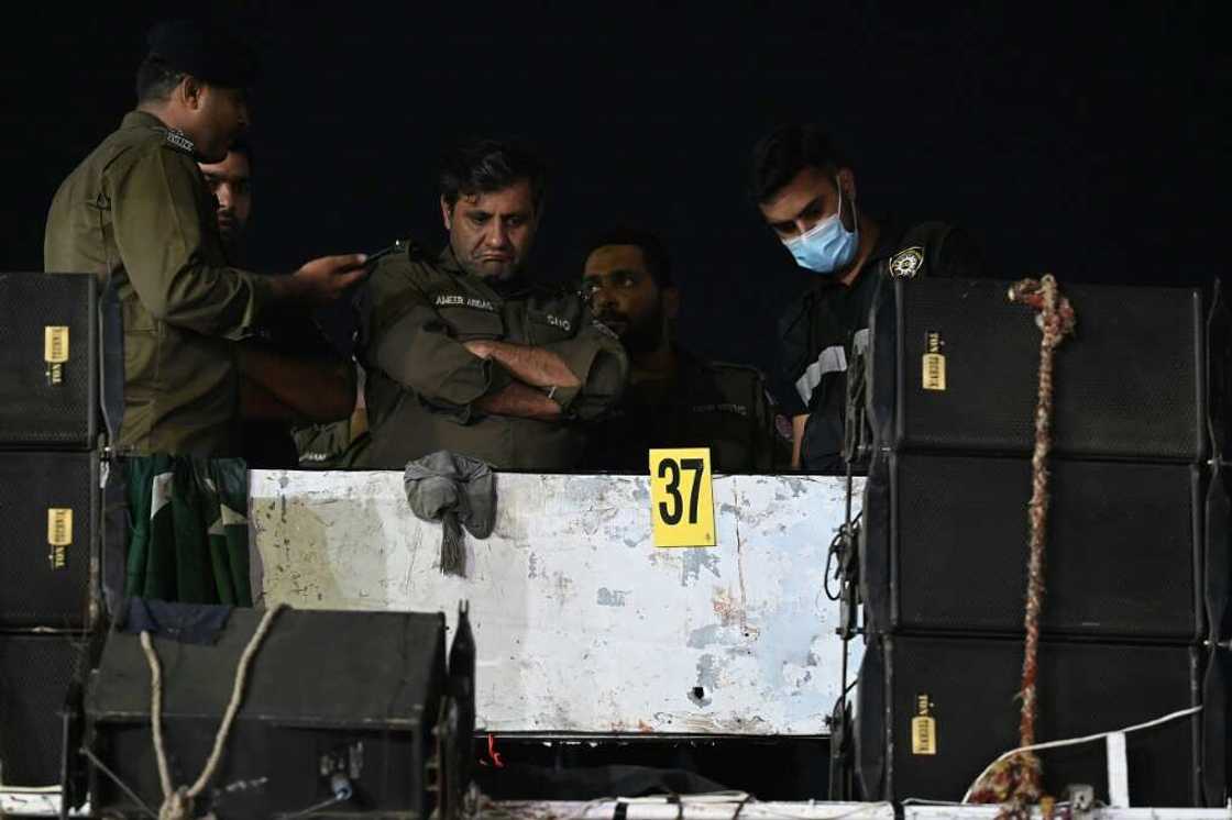 Investigators examine the rooftop of the container truck where Imran Khan was shot Investigators examine the rooftop of the container truck where Imran Khan was shot