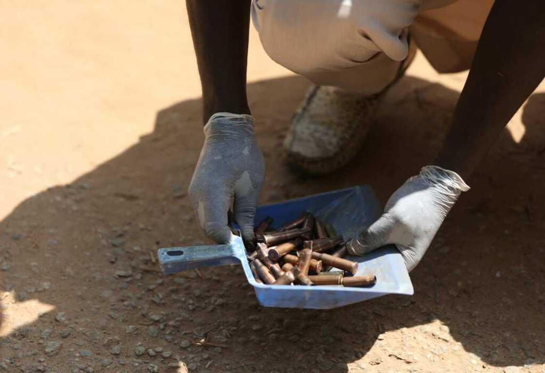 A forensic investigator gathered cartridges fired by the gunmen