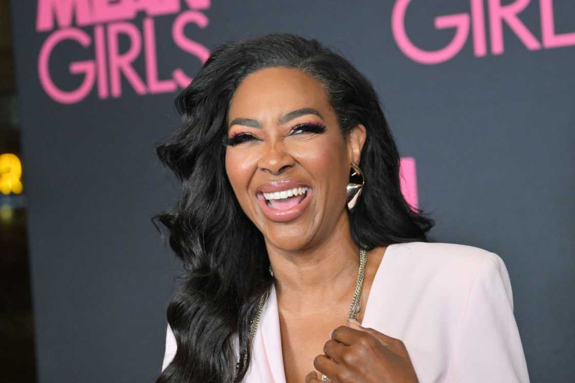 Kenya Moore laughing as she takes a photo at the Atlanta screening of "Mean Girls" at AMC Madison Yards