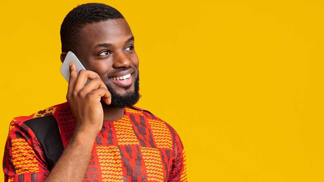 A man holds his mobile phone as a call is declined A man holds his mobile phone as a call is declined