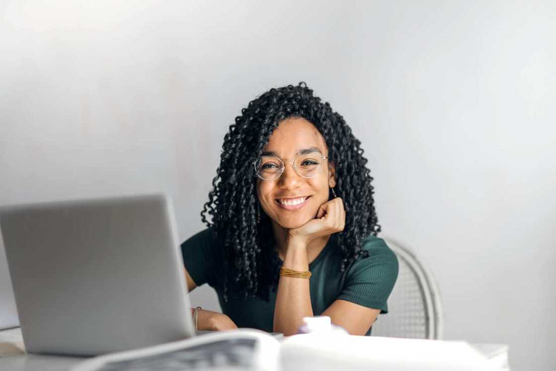 A woman sitting at table with a laptop A woman sitting at table with a laptop