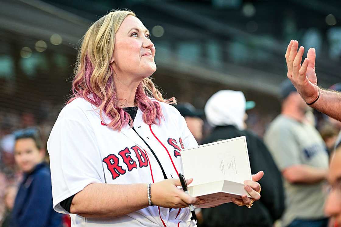 Rebecca Yarros signs copies of her book before an MLB game Rebecca Yarros signs copies of her book before an MLB game