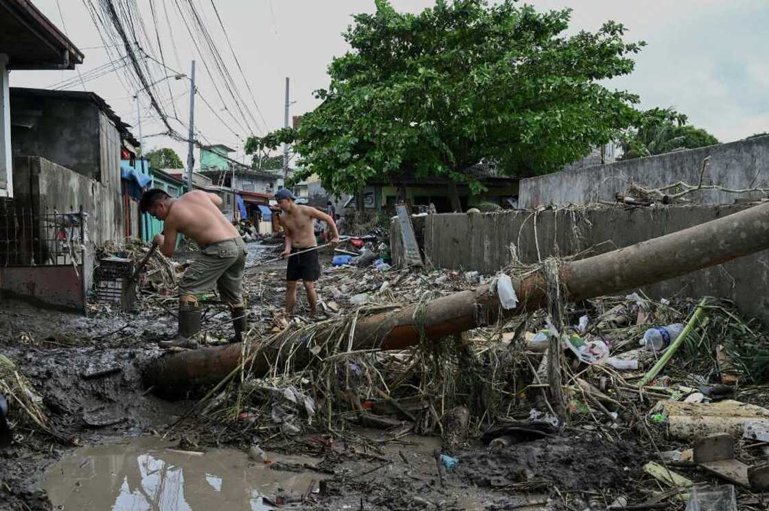 The death toll from floods and landslides unleashed by a tropical storm in the Philippiones jumps sharply to 98