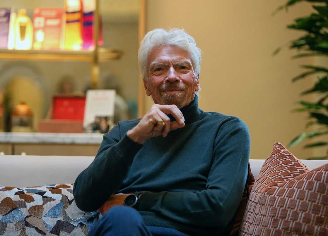 Sir Richard Branson poses sitting in a portrait Sir Richard Branson poses sitting in a portrait
