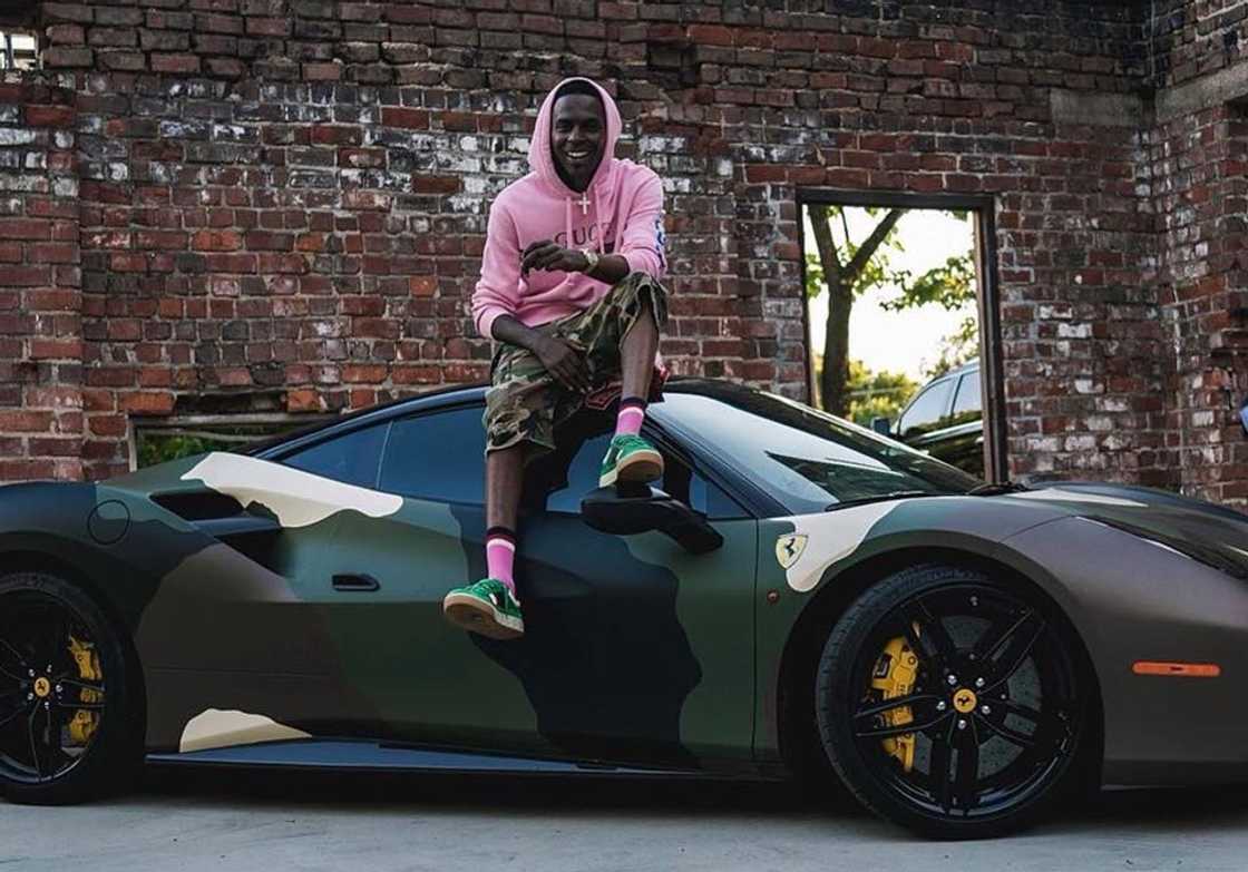 Young Dolph posing on top of his Ferrari 488 GTB Young Dolph posing on top of his Ferrari 488 GTB