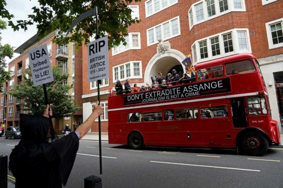 Protesters aboard a double-decker bus protested outside Britain's interior ministry against Assange's  extradition Protesters aboard a double-decker bus protested outside Britain's interior ministry against Assange's  extradition