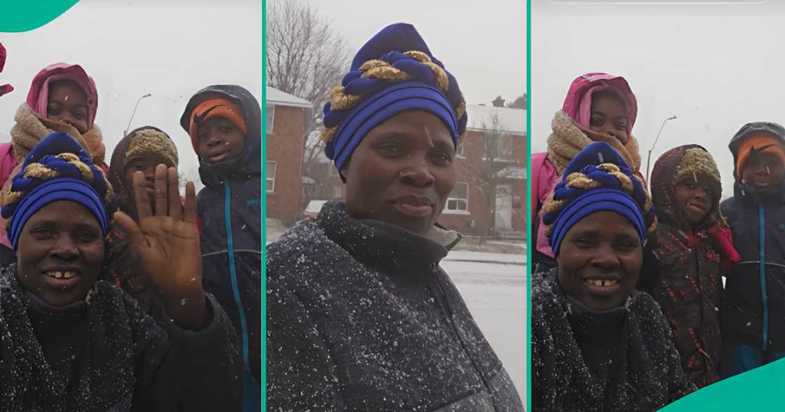 African woman celebrates with children as they experience snow for first time.