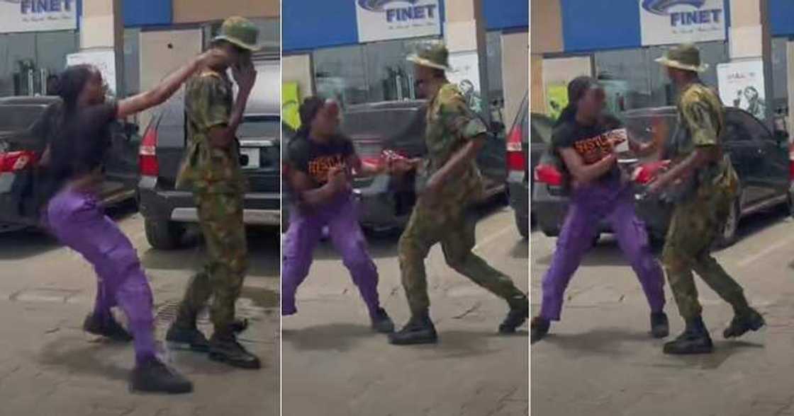 Nigerian lady drags phone from soldier