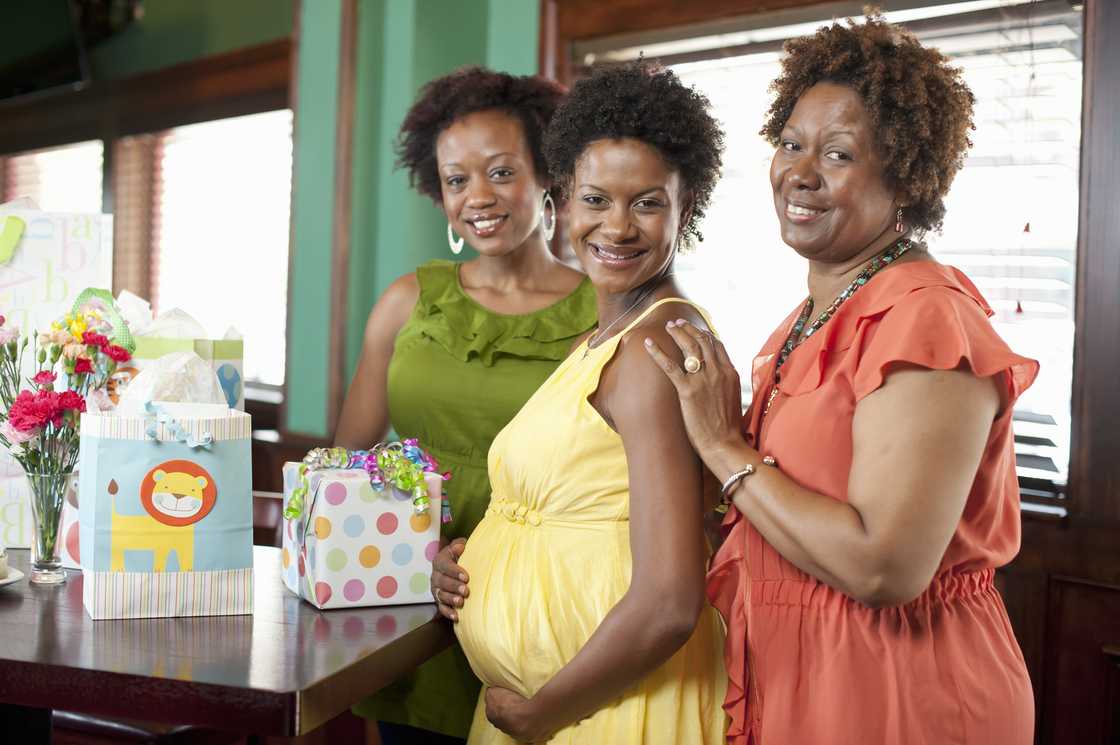 Women smiling at a baby shower Women smiling at a baby shower