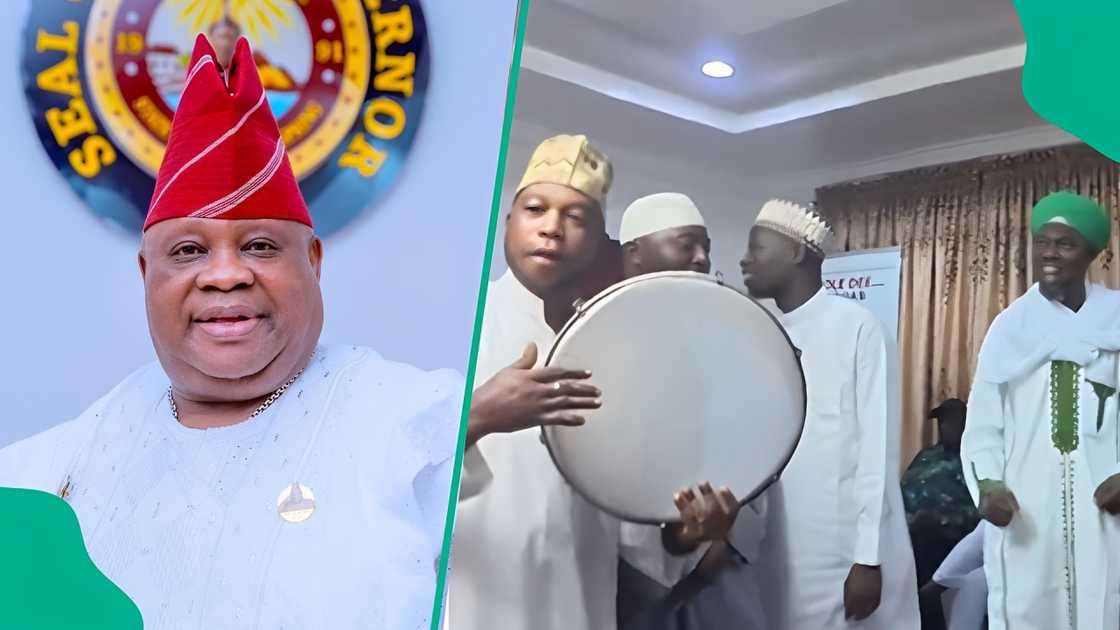 Osun governor Ademola Adeleke plays drums as Muslim clerics celebrate with him.
