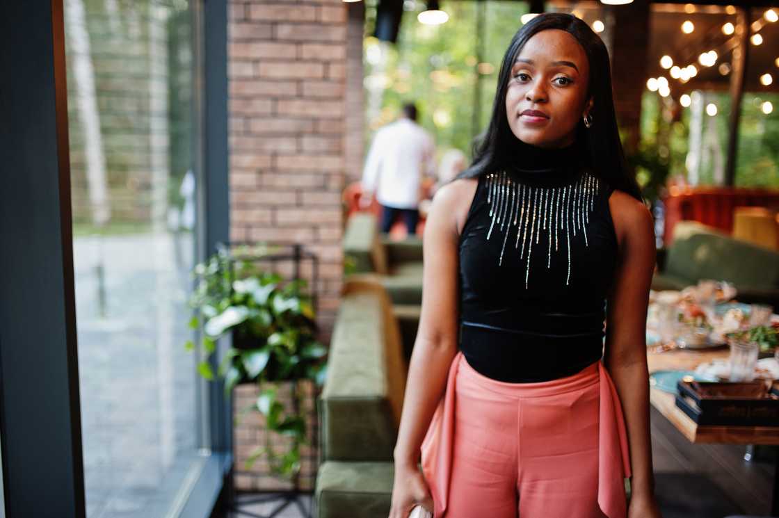 Woman leaving a restaurant table calmly, quiet determination in her expression.