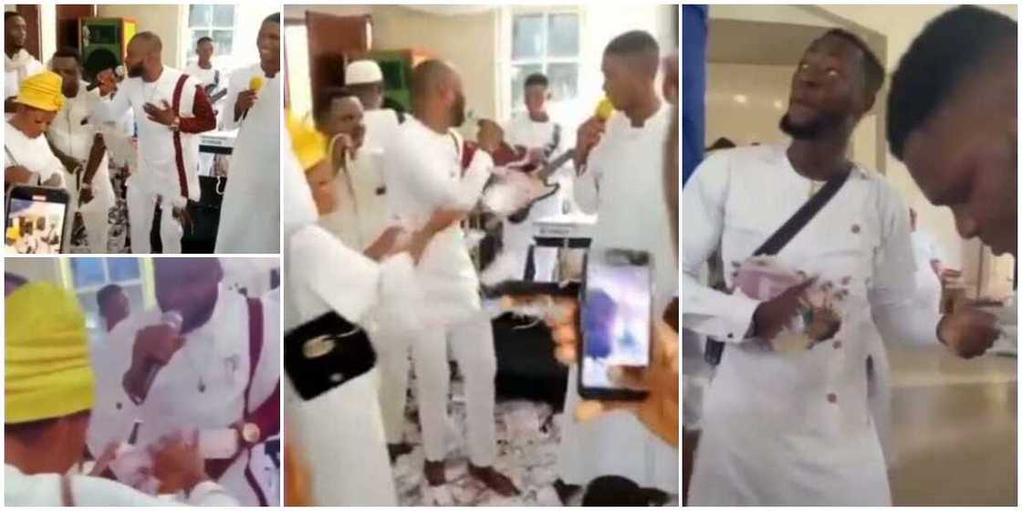 Video shows family members spraying cash on a male chorister in church, people watch them in surprise