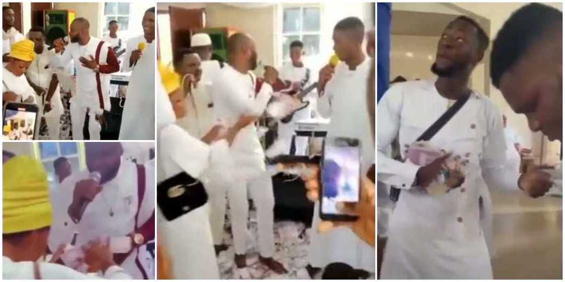 Video shows family members spraying cash on a male chorister in church, people watch them in surprise Video shows family members spraying cash on a male chorister in church, people watch them in surprise