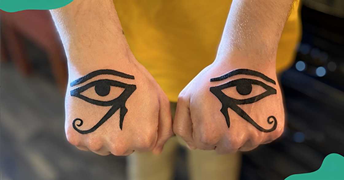 Mirror Eye of Horus tattoos on the hands.