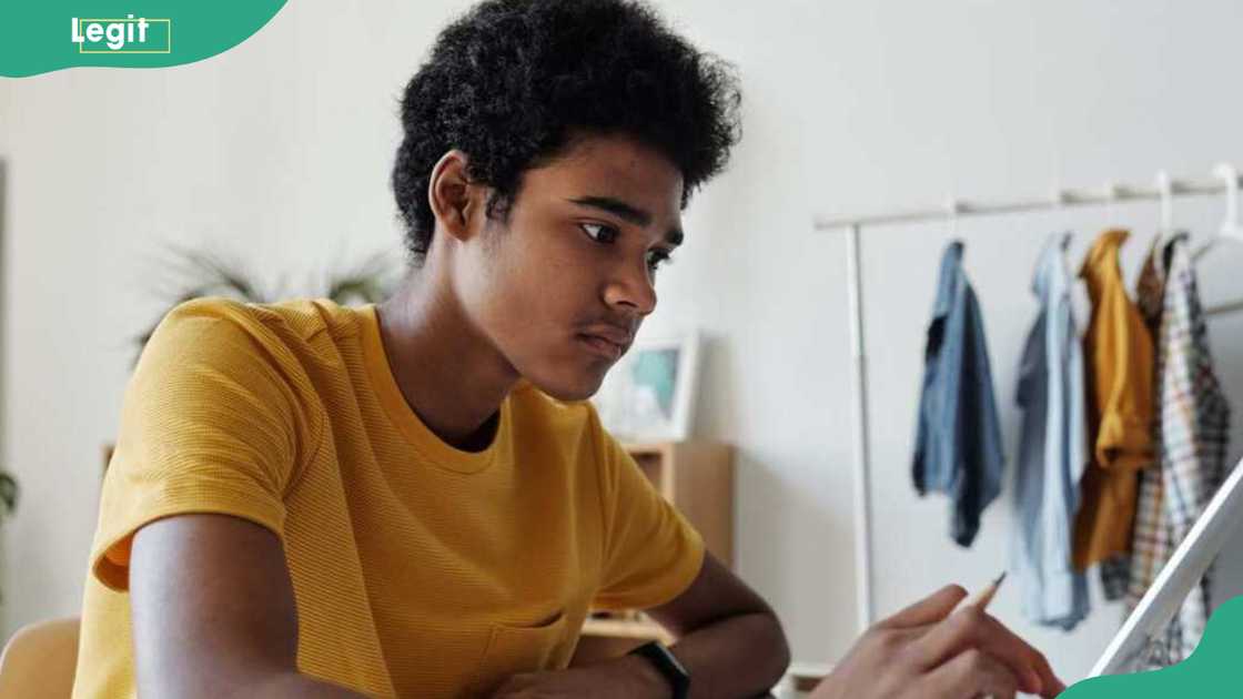 A student in yellow using a tablet A student in yellow using a tablet