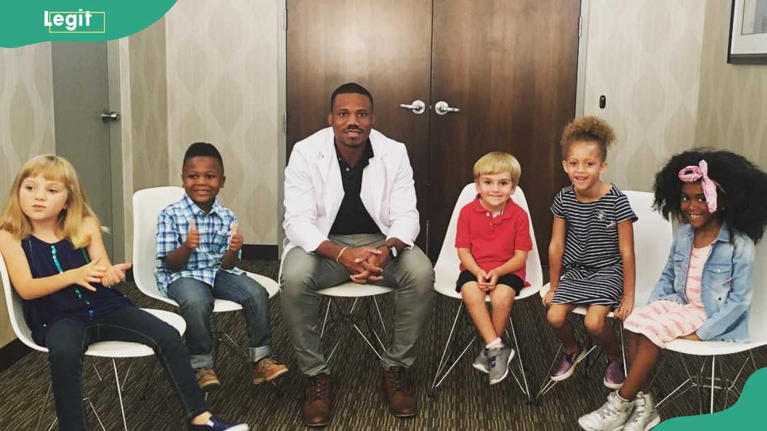 Olivier Noel poses for a photo with kids
