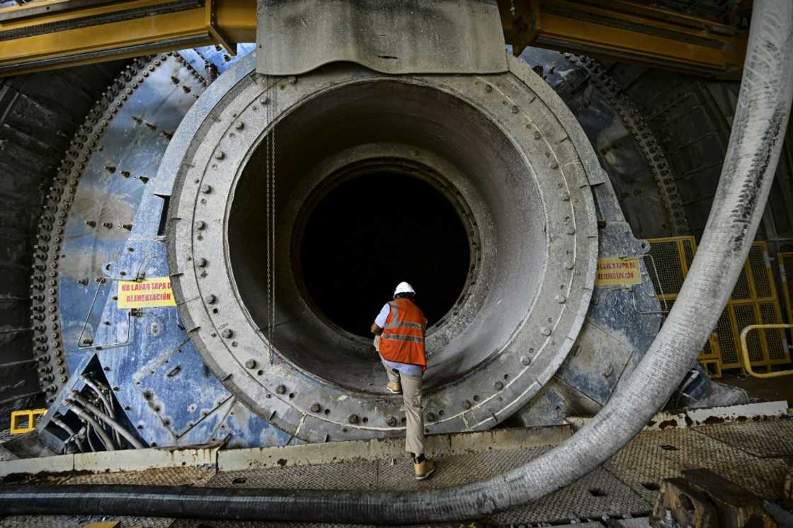 An employee inspects heavy machinery that sits unused at the Cobre Panama copper mine An employee inspects heavy machinery that sits unused at the Cobre Panama copper mine