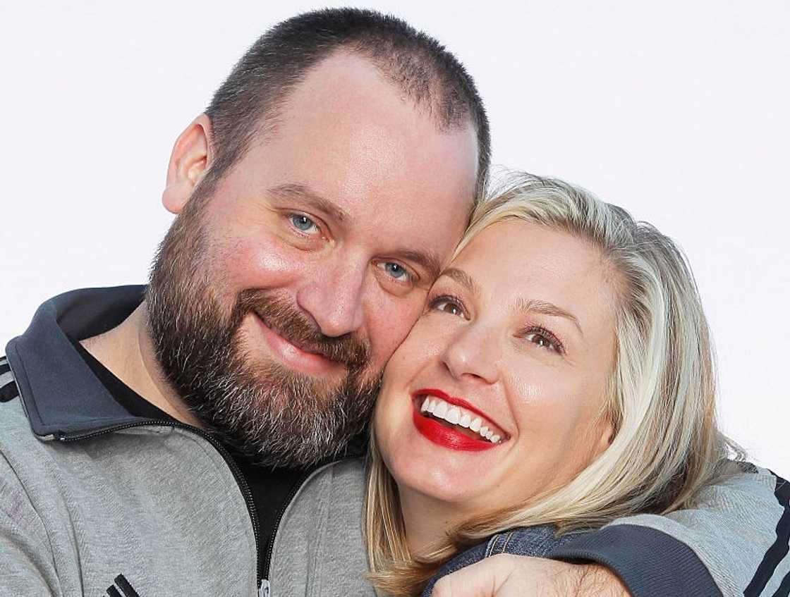 Tom Segura and Christina Pazsitzky pose holding each other