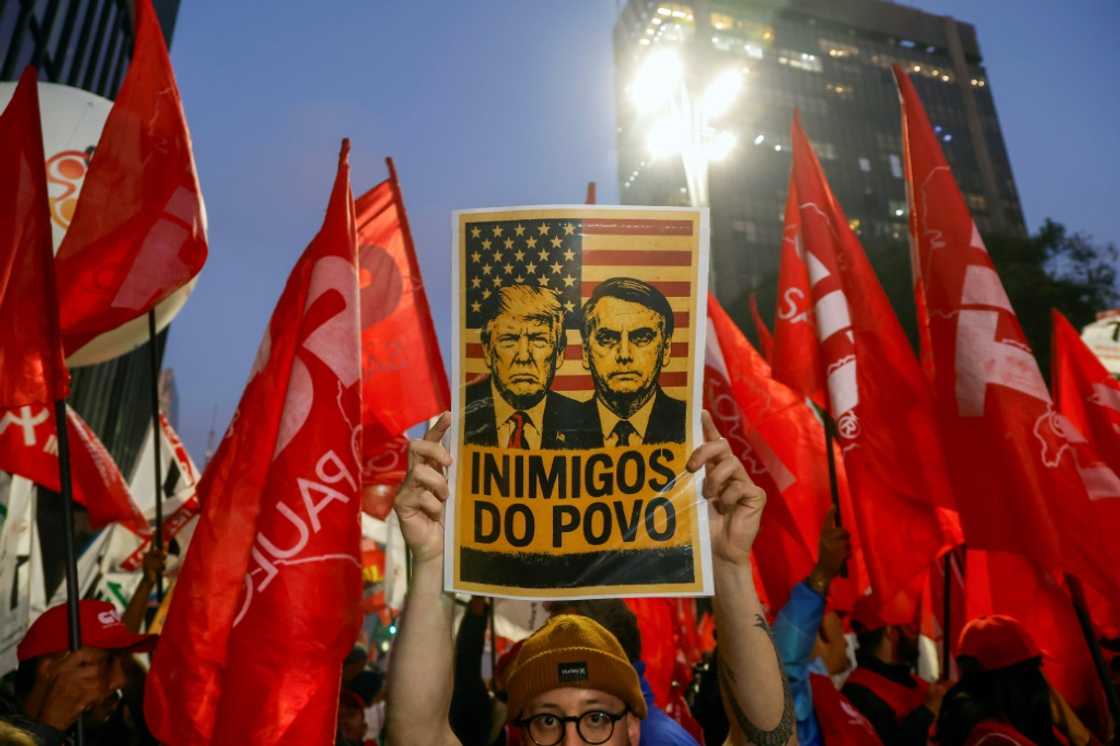A poster declaring US President Donald Trump and erstwhile Brazilian President Jair Bolsonaro 'Enemies of the people' astatine a objection successful Sao Paulo A poster declaring US President Donald Trump and erstwhile Brazilian President Jair Bolsonaro 'Enemies of the people' astatine a objection successful Sao Paulo