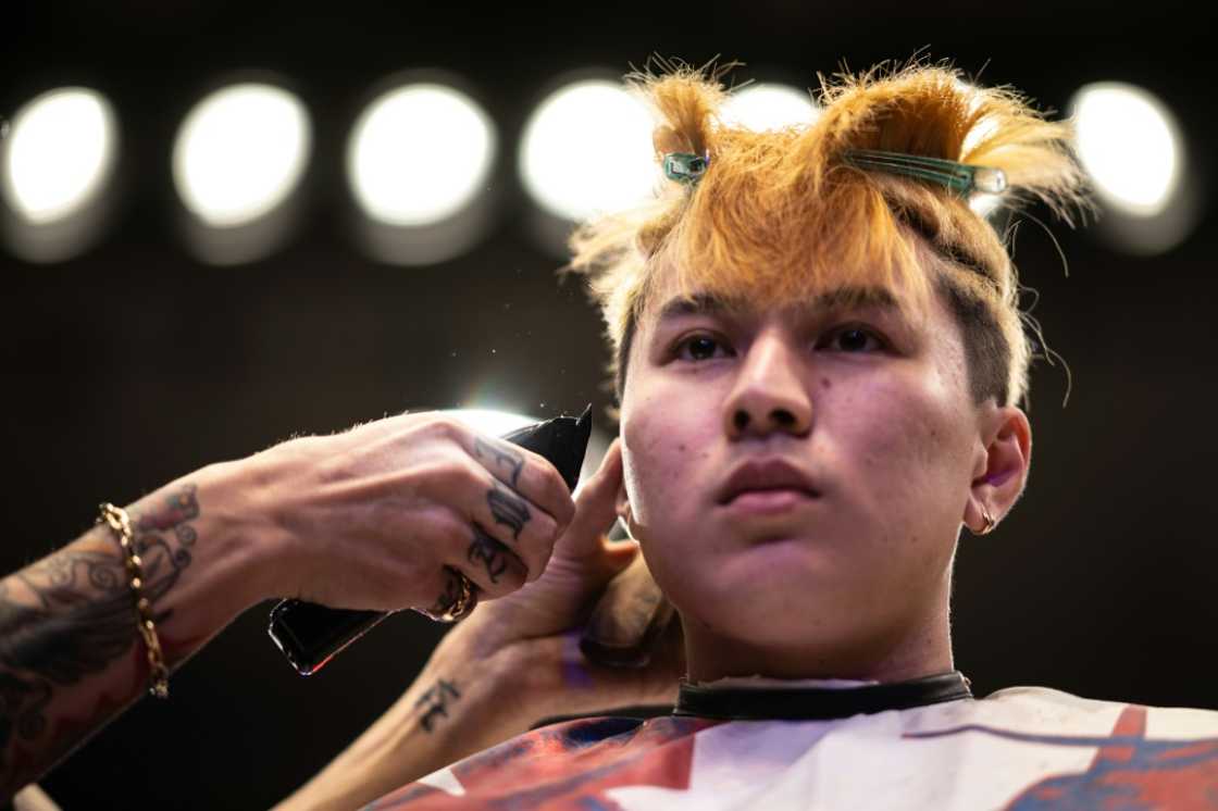 A barber gives a model a haircut during the World Barber Classic in Tokyo A barber gives a model a haircut during the World Barber Classic in Tokyo