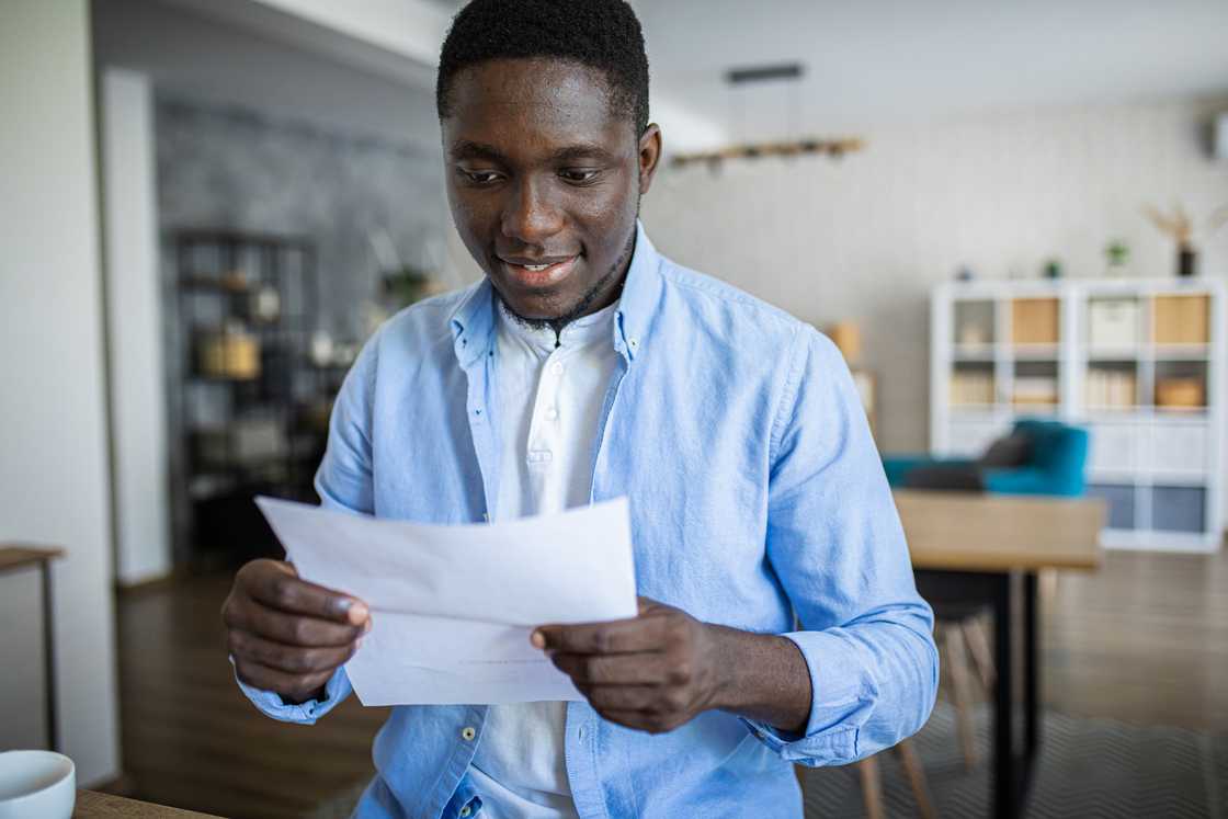 a young man holding internship letter