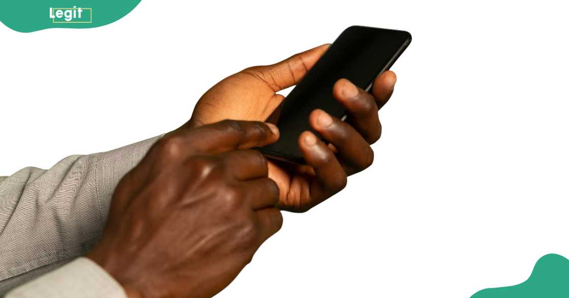 A close up of the hands of a young man using a smartphone A close up of the hands of a young man using a smartphone