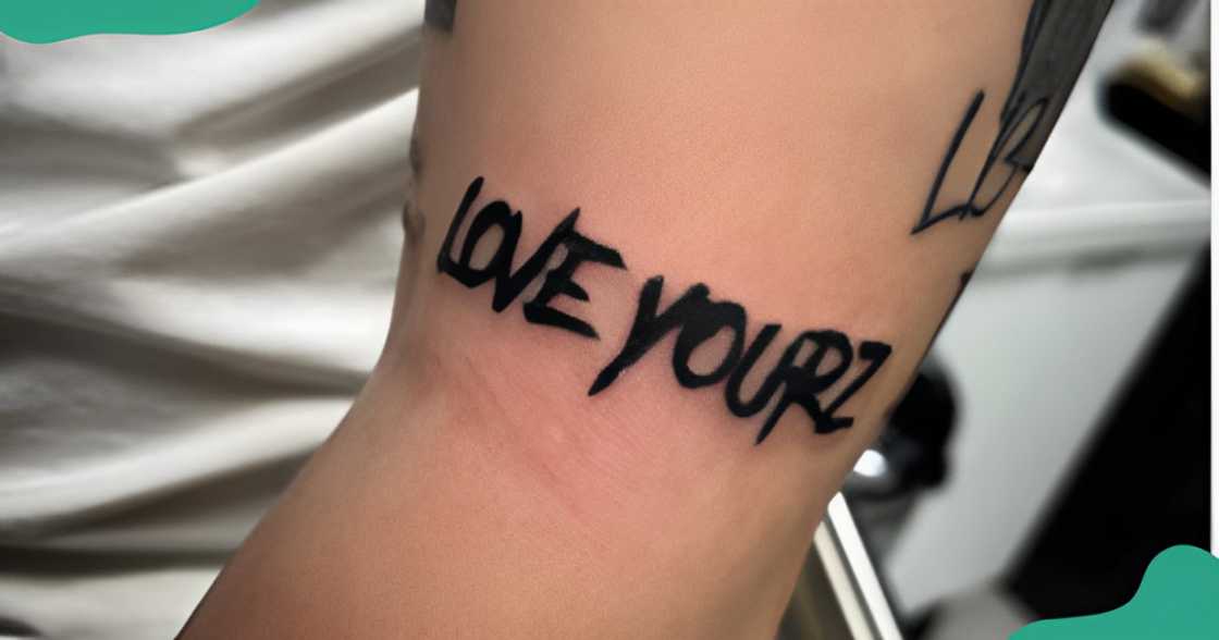 A Love Yourz tattoo on the arm