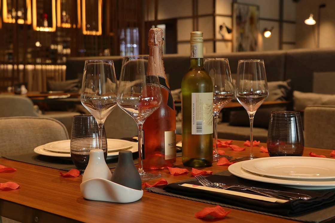 Two bottles of wine and wine glasses on top of a table at Wakame Restaurant, Lagos Two bottles of wine and wine glasses on top of a table at Wakame Restaurant, Lagos