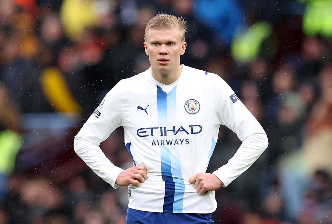 Earling Haaland in a white jersey during a football match. Earling Haaland in a white jersey during a football match.