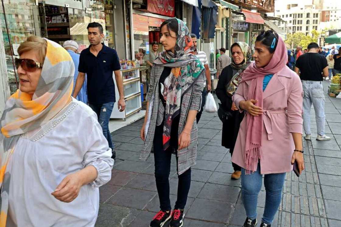 Iranian women shop in the capital Tehran on Tuesday: women, must wear a headscarf covering their hair in public