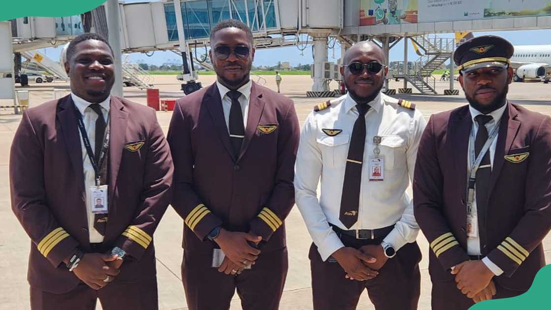 Young pilots lineup for a photo at an airport
