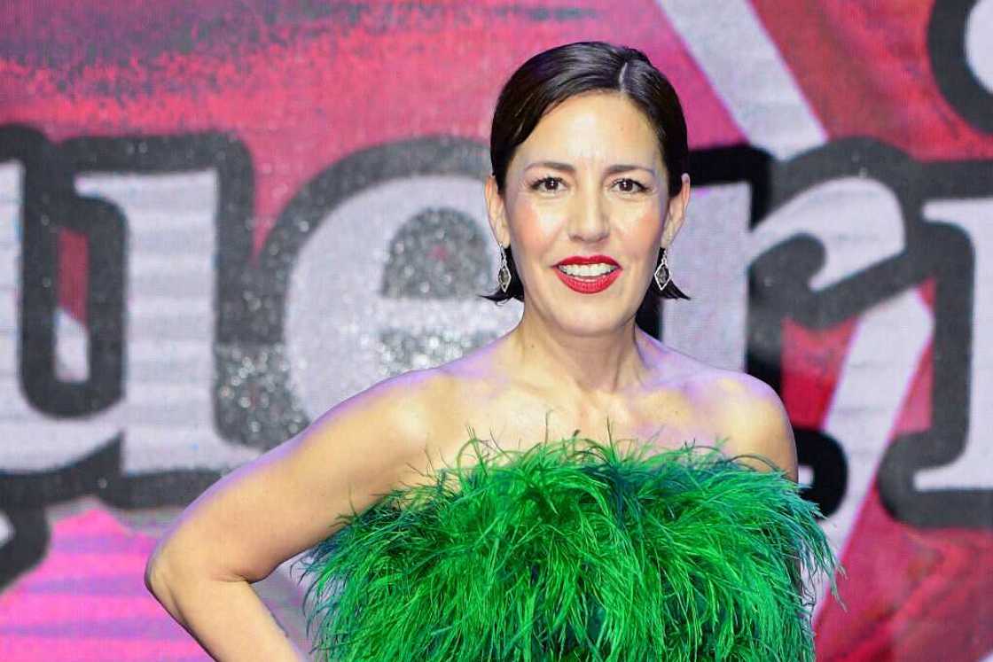 Stephanie Salas poses for a photo in a green fury dress