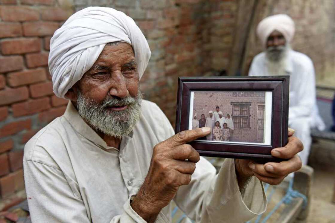 Indian Sikh labourer Sika Khan shows his elder brother Sadiq Khan's picture during an interview with AFP Indian Sikh labourer Sika Khan shows his elder brother Sadiq Khan's picture during an interview with AFP