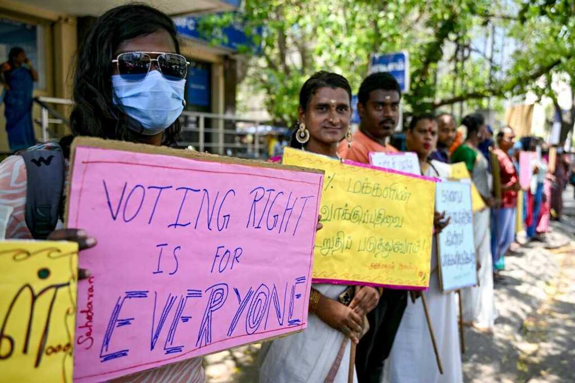 Members of the transgender community hold placards to create voter awareness