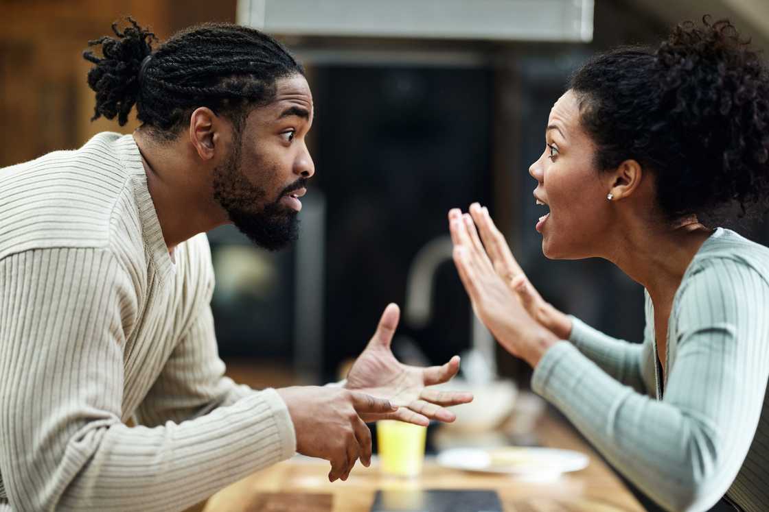 A displeased couple arguing at home