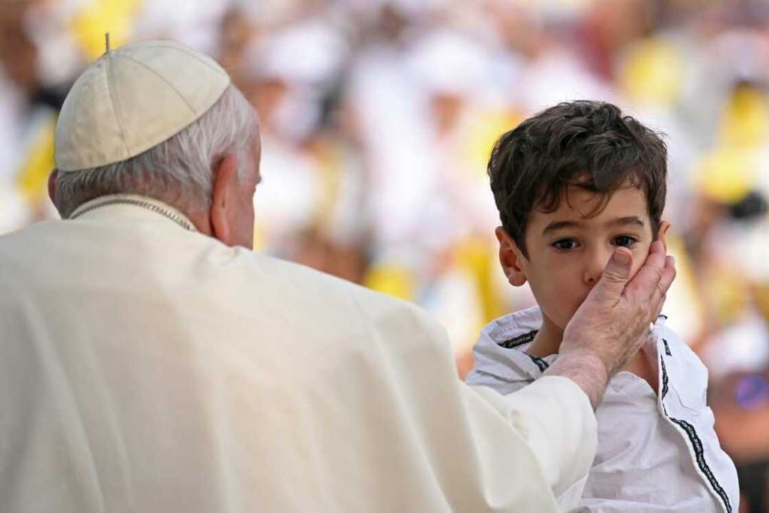Francis blesses a child at the stadium Francis blesses a child at the stadium
