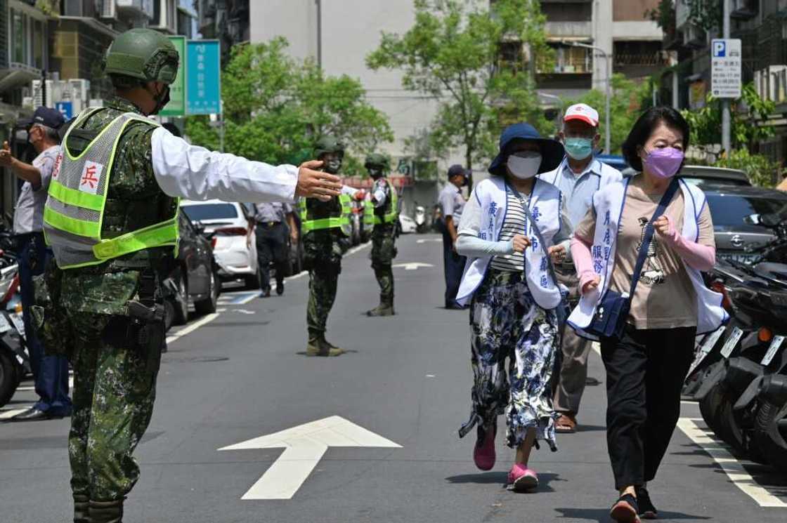 Civilians clear the streets in Taipei as part of an air-raid drill Civilians clear the streets in Taipei as part of an air-raid drill