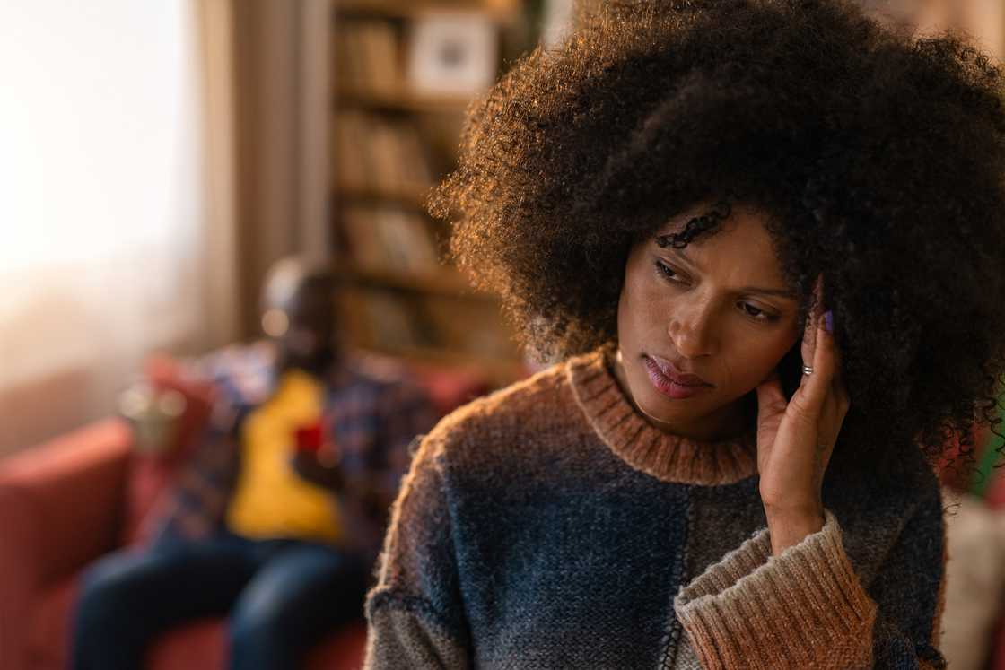 A woman having an argument with her boyfriend sitting