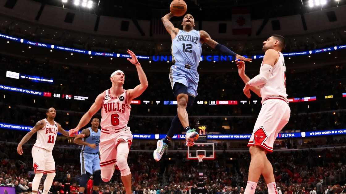 Ja Morant of the Memphis Grizzlies jumps to dunk (Blue).