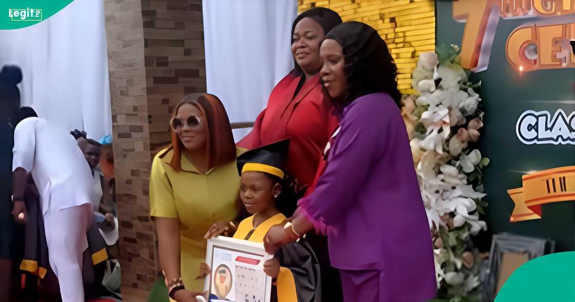 A Nigerian mother reacts after she saw the items her 3 children received at their school party.