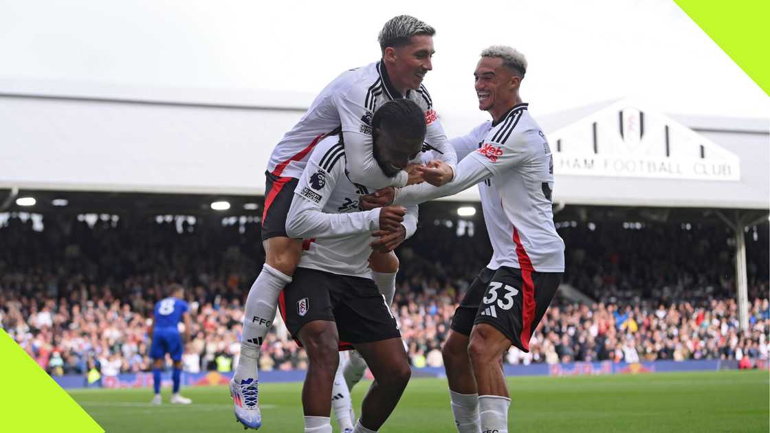 Alex Iwobi celebrates with his teammates after scoring for Fulham against Leicester City.