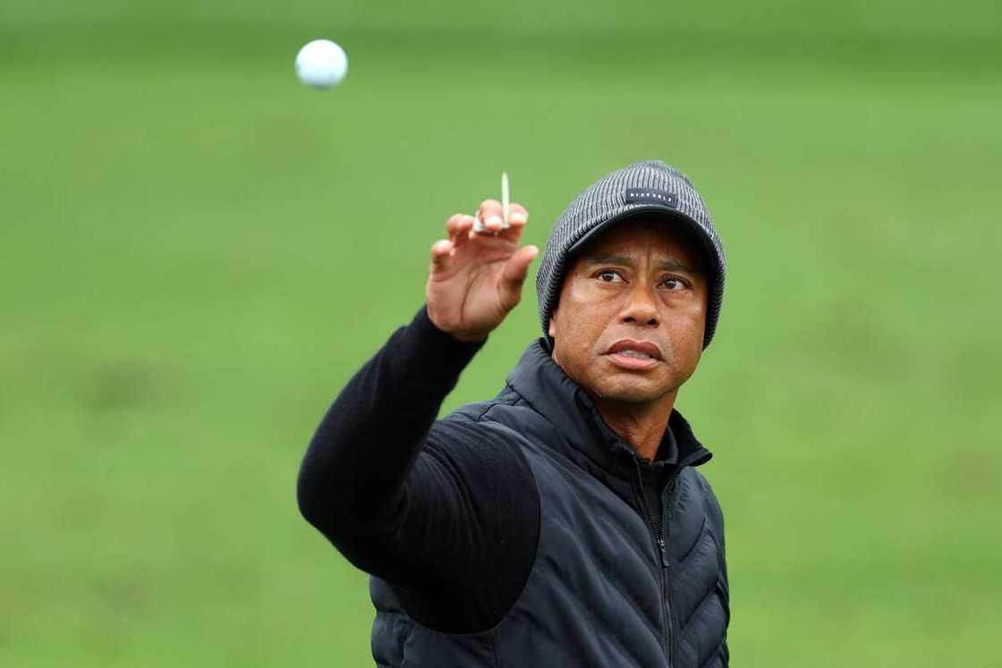 Tiger Woods of the United States catches a ball on the practice area during the third round of the Masters Tournament at Augusta National Golf Club