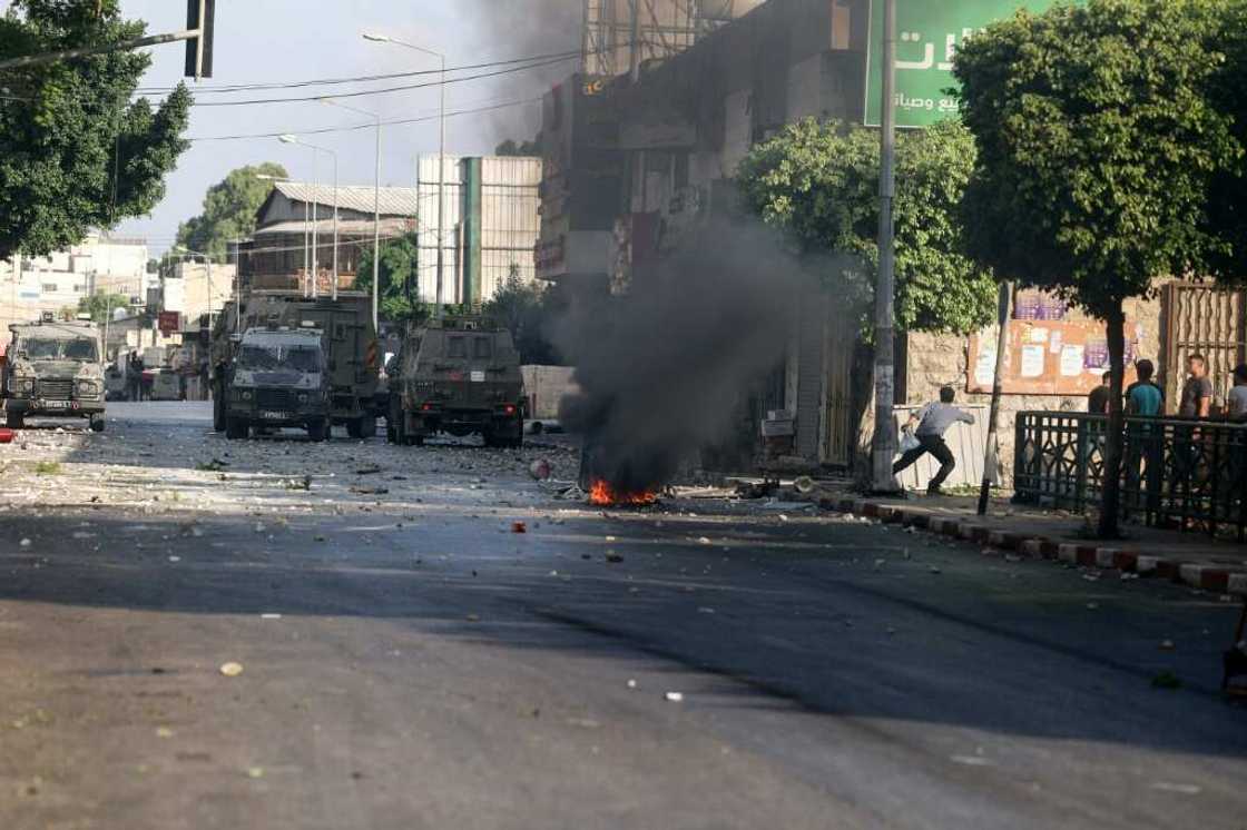 Young Palestinians clash with Israeli troops carrying out an arrest raid in the city of Nablus in the occupied West Bank