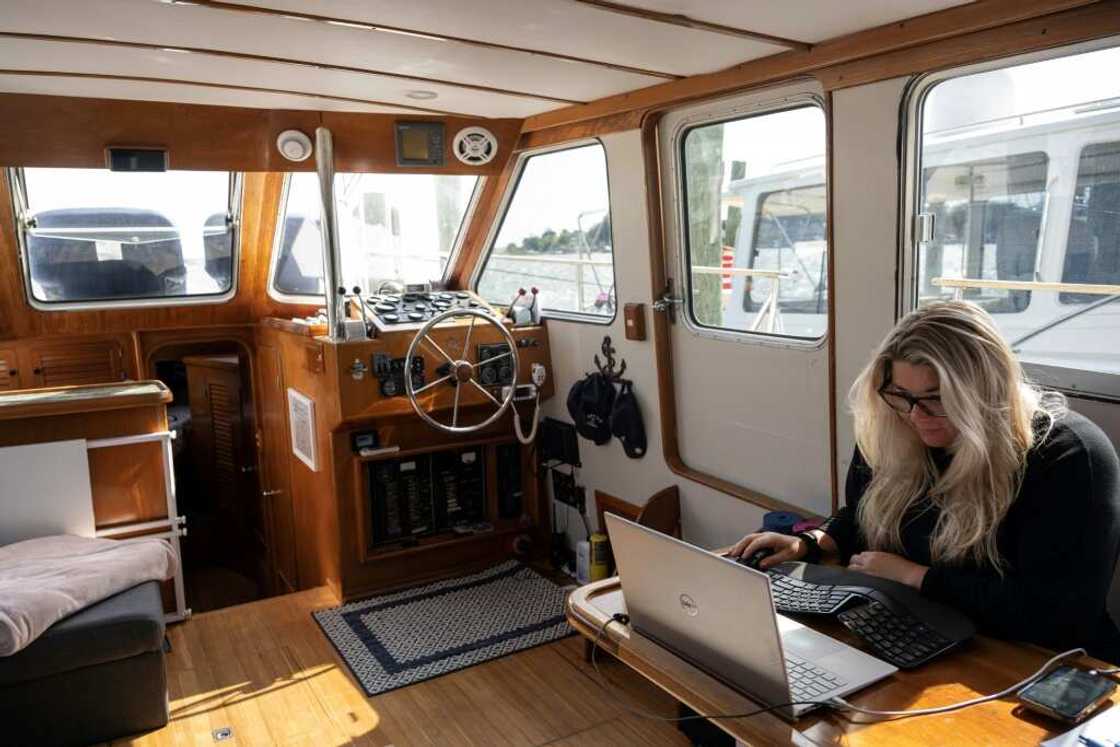 Amy Whetzel works in her boat, Miranda, anchored in Mayo, Maryland, about an hour's drive form the US capital