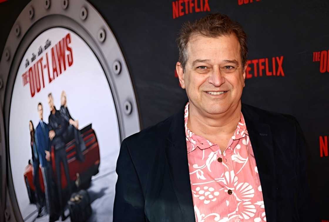 Allen Covert poses on the red carpet of the screening of The Out-Laws