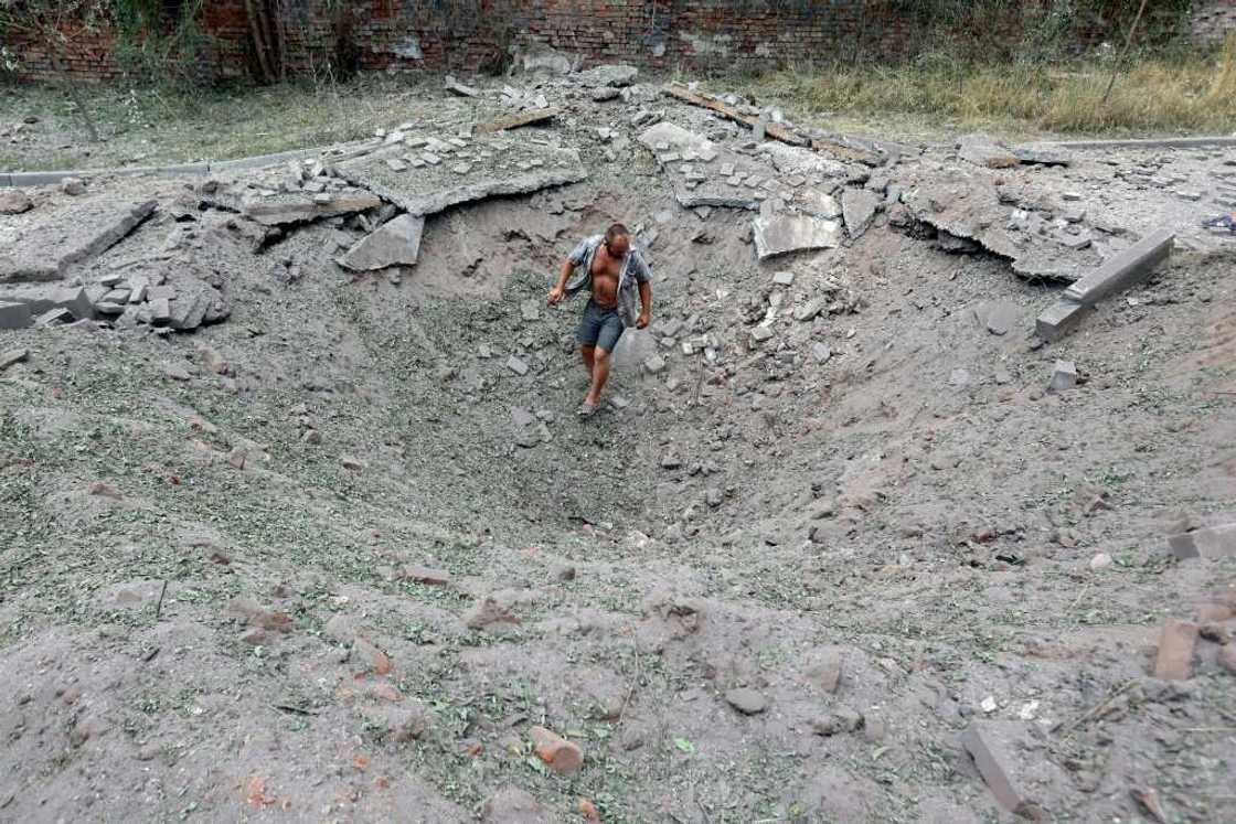A man walks in a crater following a missile strike in the town of Kostyantynivka A man walks in a crater following a missile strike in the town of Kostyantynivka