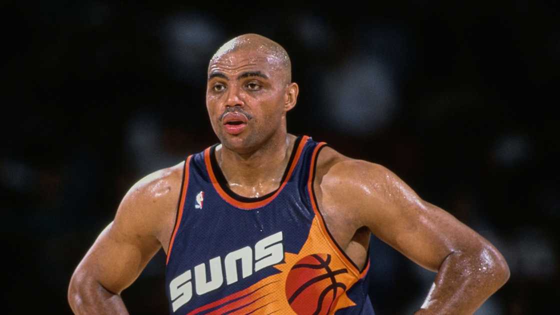 Charles Barkley of the Phoenix Suns looks on with hands on hips