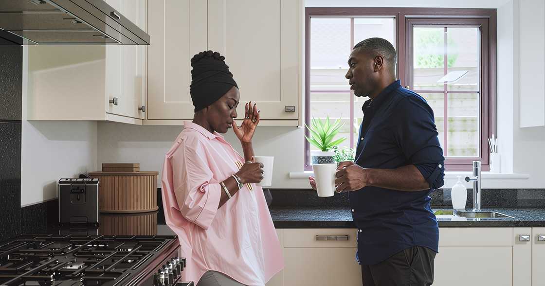 A black couple in a kitchen argues