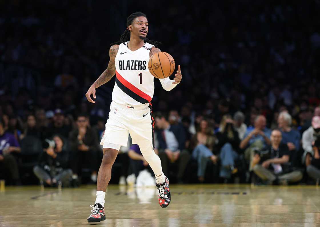 Ja Morant in a white Trail Blazers No. 1 jersey dribbling up the court at Crypto.com Arena in Los Angeles, 2026